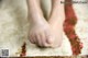 A close up of a person's feet on a rug.