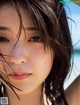 A woman with wet hair on the beach. 