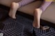 A close up of a person's legs on a table.