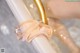 A close up of a ballerina's feet in a bathtub.