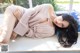 A woman laying on top of a window sill.